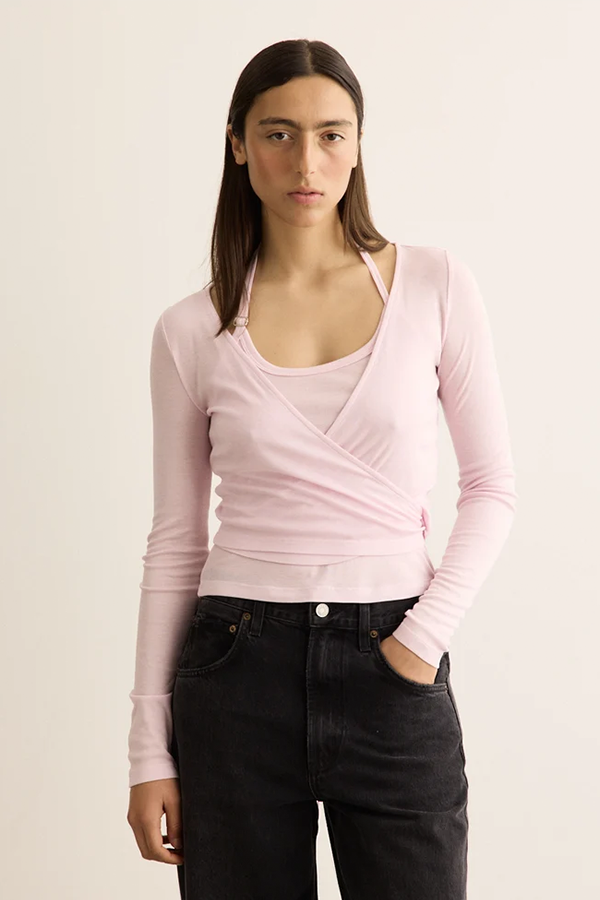 Designed for versatile styling, the Double Halt Wrap Top features two detachable pieces that can be layered together or styled separately. Crafted from a soft cut-and-sew jersey blend with a touch of silk for a premium feel, it combines a classic long-sleeve wrap top with an adjustable halter-neck inner layer.