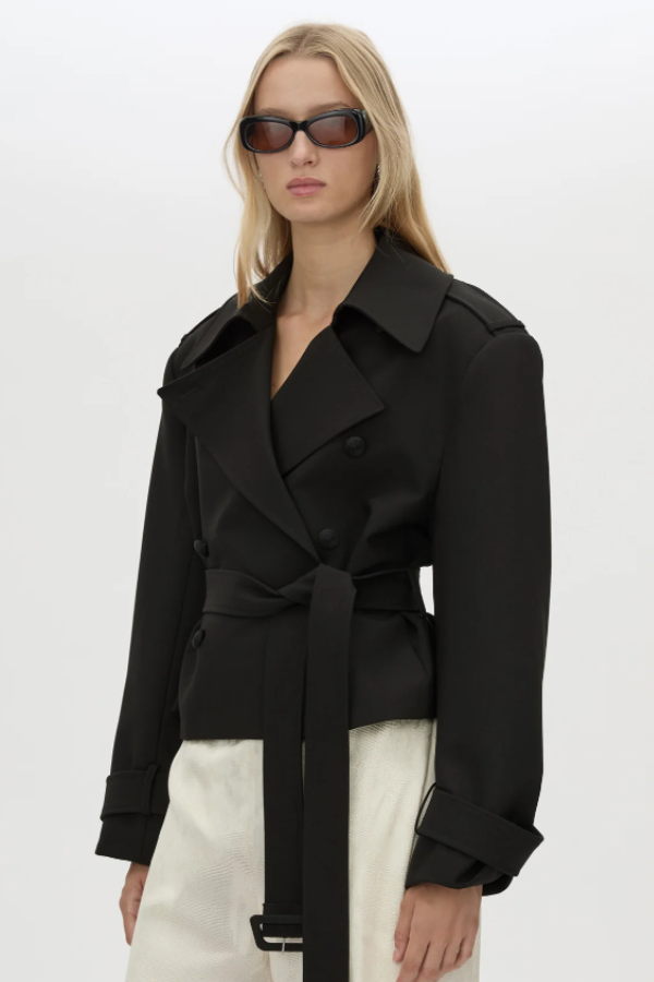 CAMILLA AND MARC cropped Asena Short Trench in black with double breasted closure. Shoulder pads, shoulder epaulettes, cord covered buttons and side seam pockets.