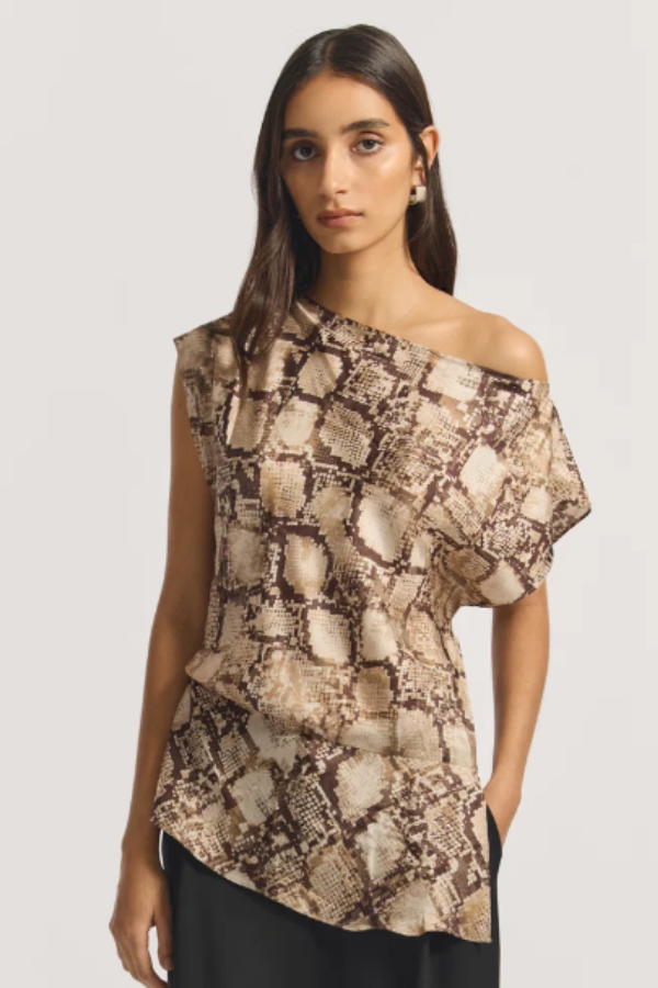 The Torrance Top in python print, made in Australia. A bias-cut silhouette in silk twill, featuring a soft boat neckline, extended shoulders, and side-tuck detailing for fluid proportion. Pair with the Skylark Pant for a striking, tonal statement. Designed to be relaxed, size down for a more neat silhouette.
