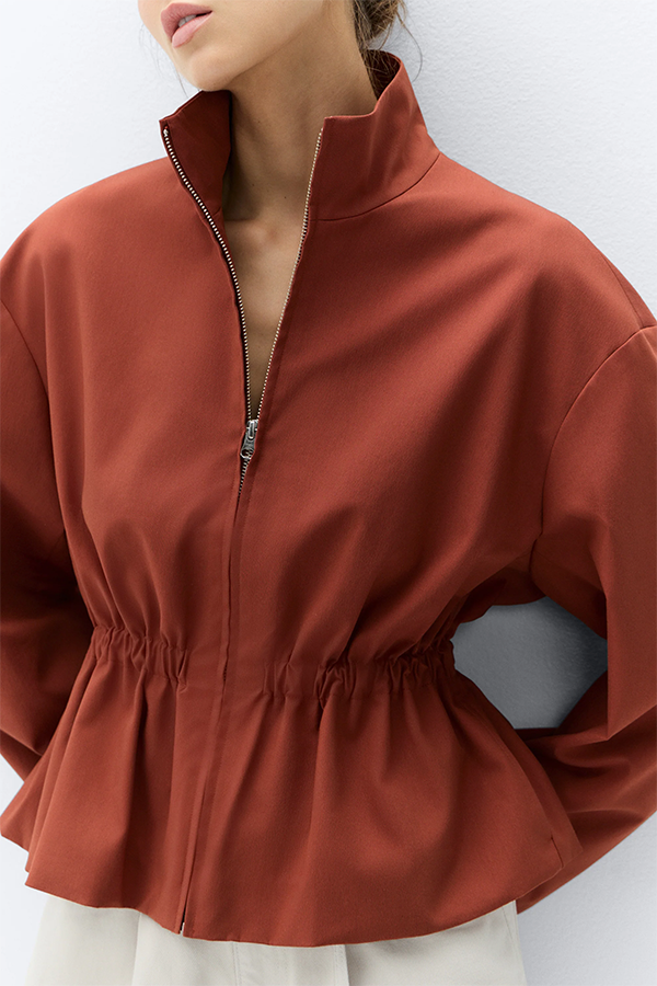 Modern proportions meet everyday ease. This lightweight jacket has an elasticated waist to create a peplum profile that sits perfectly over jeans and pants. It features a centre front zip opening and high funnel neck. Pair it with our matching Harem Pant for a relaxed look with soft volume.