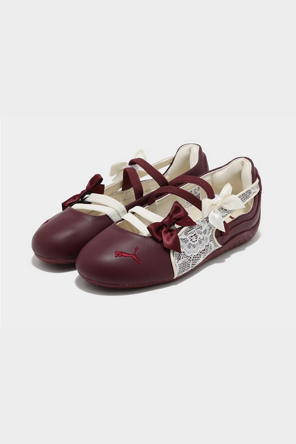 The iconic Speedcat sneaker returns in a low-profile form with the women's Speedcat Ballet from Puma. Landing in a Maroon colourway with Off White details, this sneakerina has a low profile silhouette paired with sleek details inspired by motorsport racing. The shoe's popularity has taken it from motor racing to the fashion world, with its vibrant colours and easy to wear design making it a must-have staple for your sneaker rotation. Crafted from a Suede upper for an elevated look, a rubber outsole underneath provides traction, and adjustabe bands over the foot for a locked-in feel. Finished off with the signature PUMA formstrip to the sidewalls, and the iconic PUMA silhouette embroidered to the toebox.
