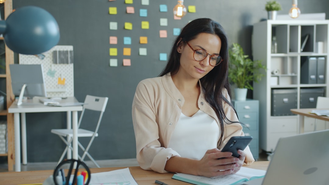 Manager using a mobile workforce management app to coordinate HR and scheduling tasks