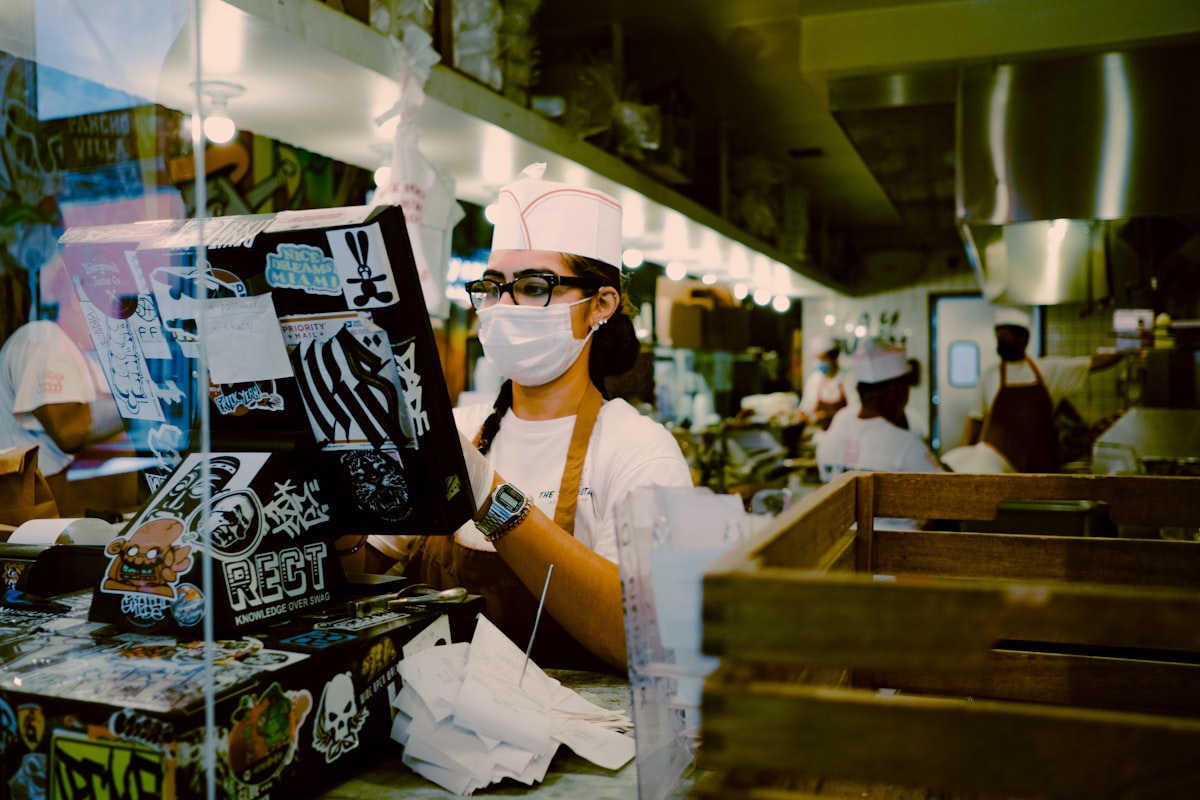 Hotel staff member reviewing a schedule at the front desk