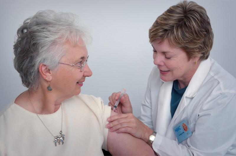 Aged care nurse assisting an elderly resident in a care facility