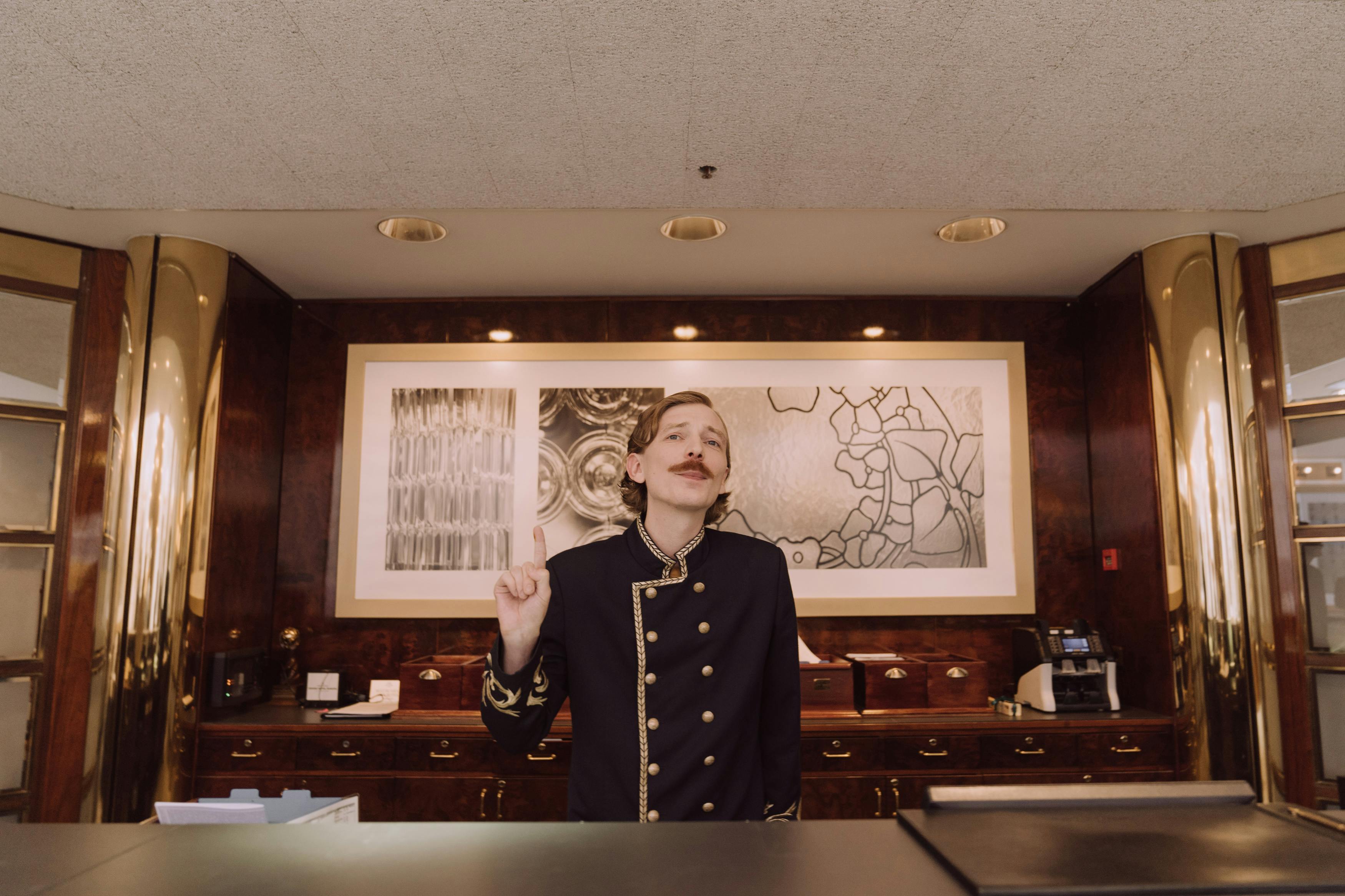 Hotel receptionist working at the front desk in a lobby