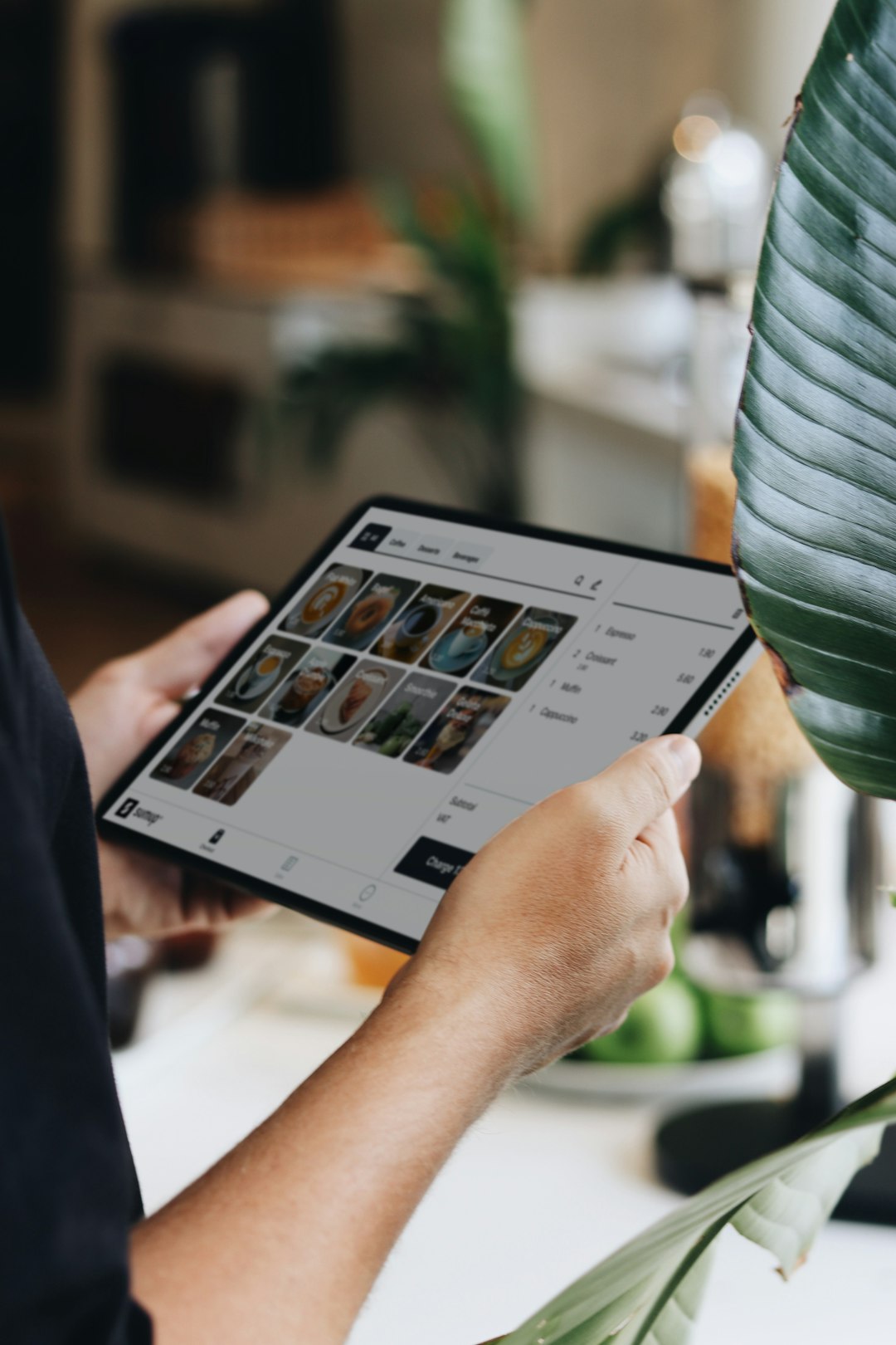 Retail manager using a tablet POS dashboard to review sales data and forecast staffing demand