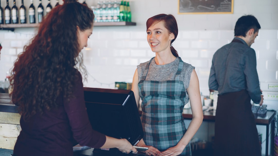 Hospitality staff serving customers in a busy coffee shop