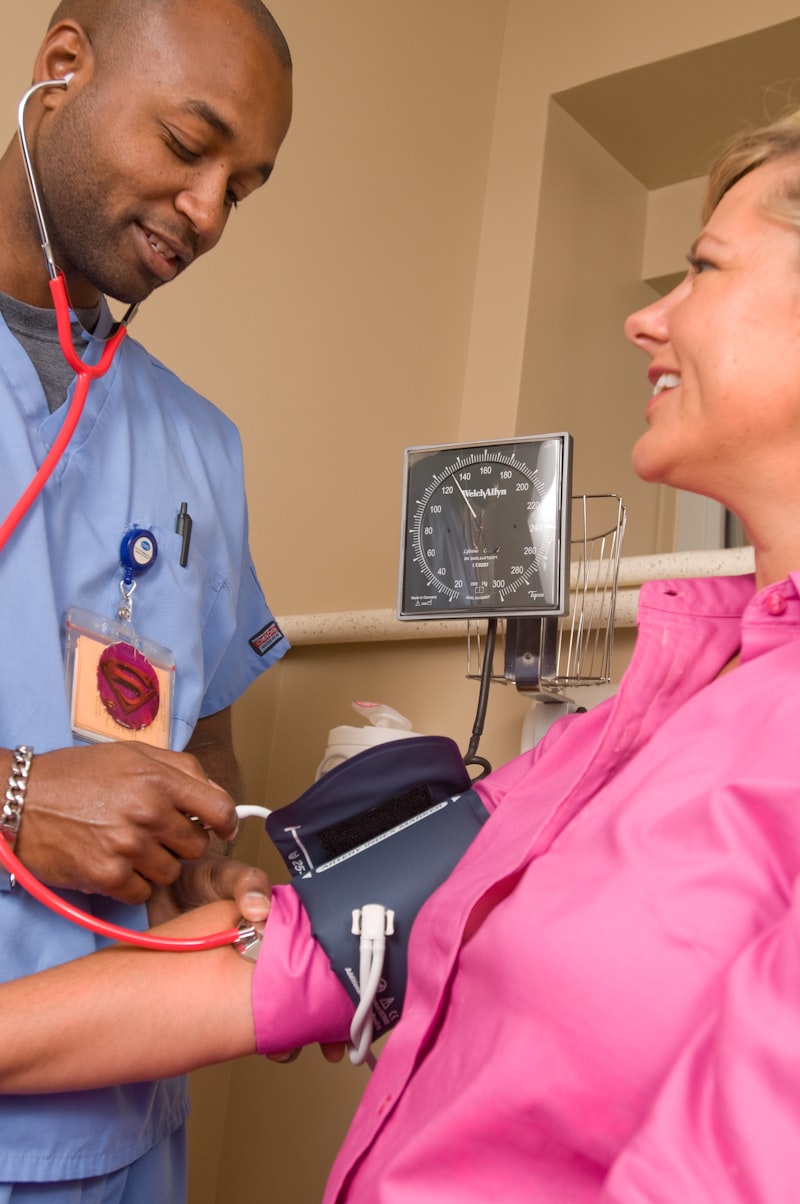 Healthcare workers reviewing patient data on a tablet in a clinical setting