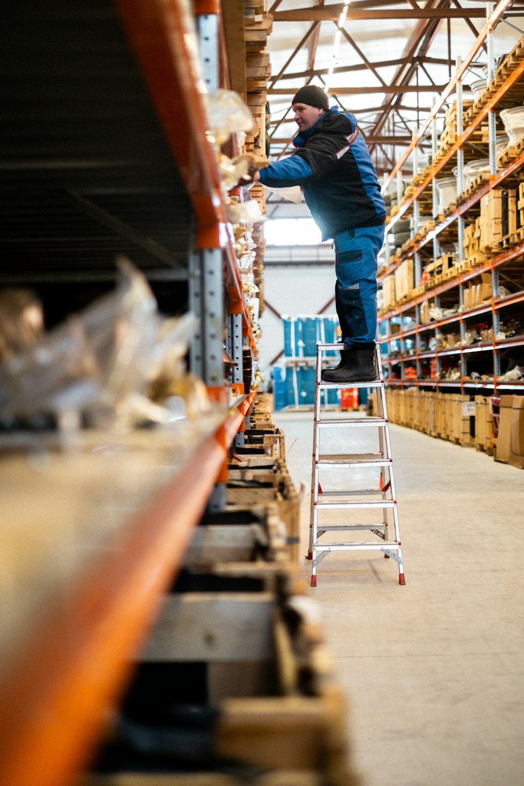 Retail stockroom worker handling inventory during a long shift to illustrate scheduling-related burnout
