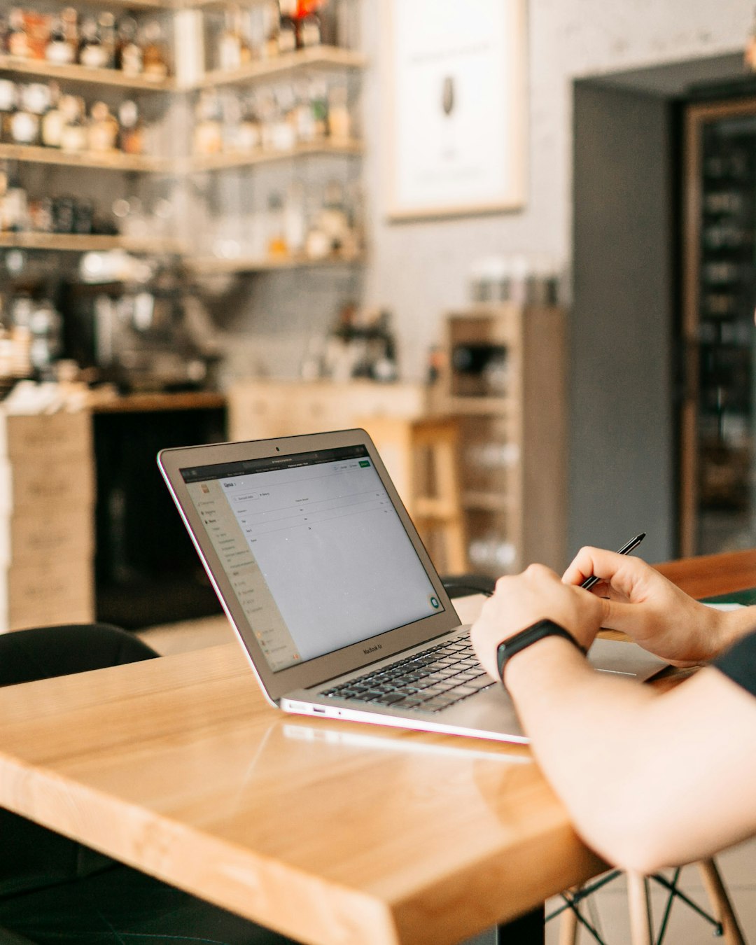Restaurant manager using scheduling software on a laptop to build the rota