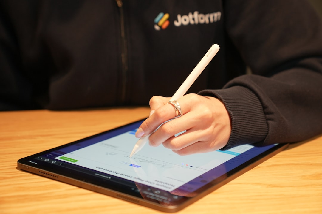 New employee signing onboarding paperwork with an electronic signature on a tablet