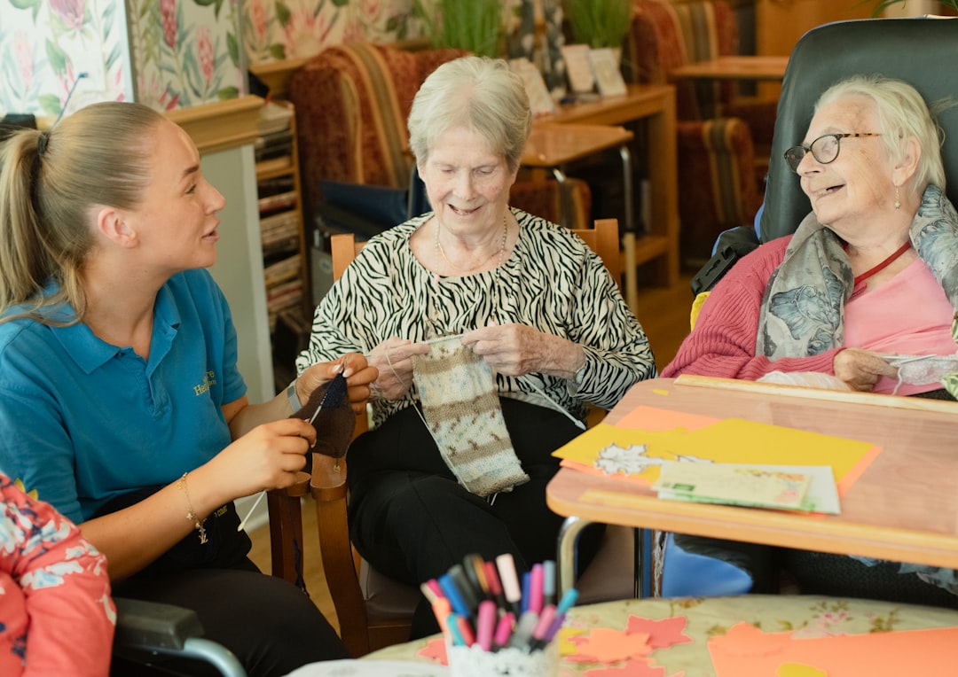 Aged care worker supporting elderly residents during a group activity