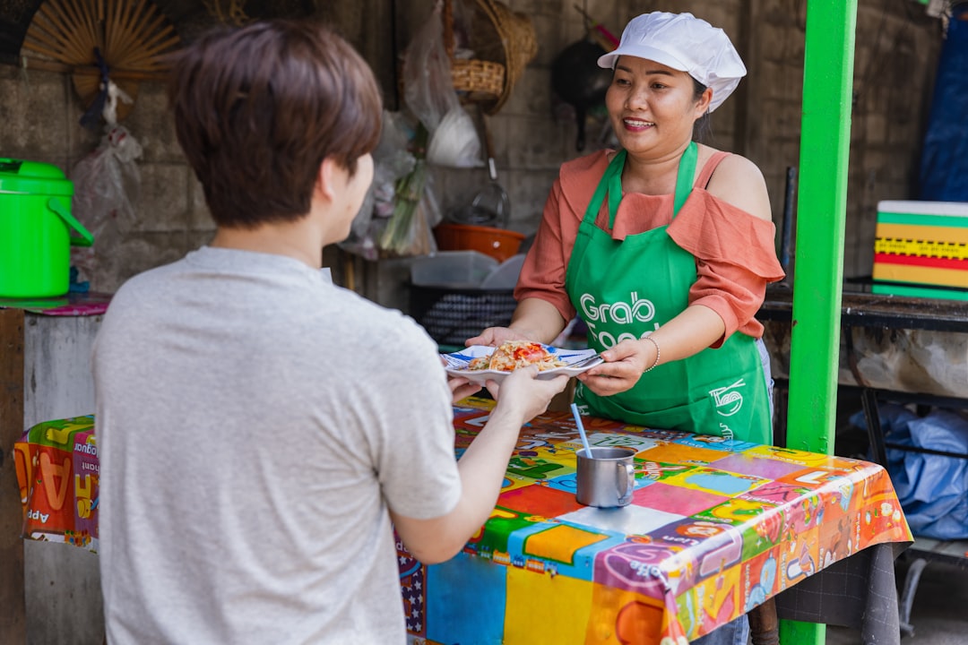 Cafe worker serving a customer in a busy hospitality setting
