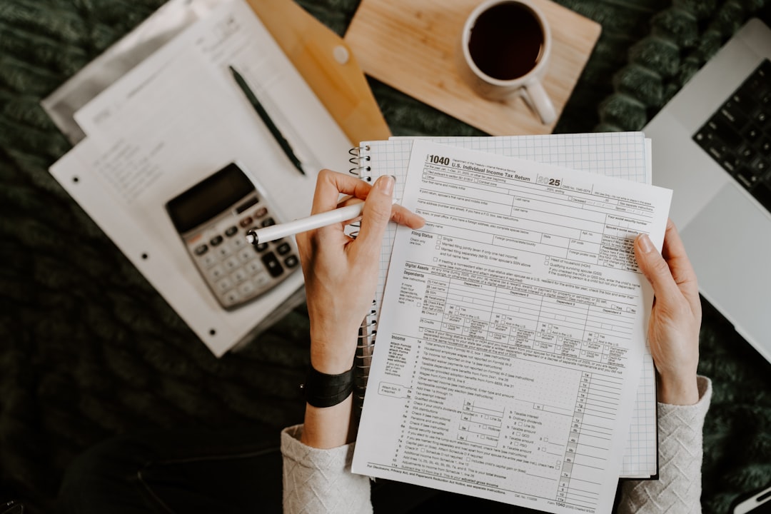 Payroll clerk reviewing timesheets and overtime calculations