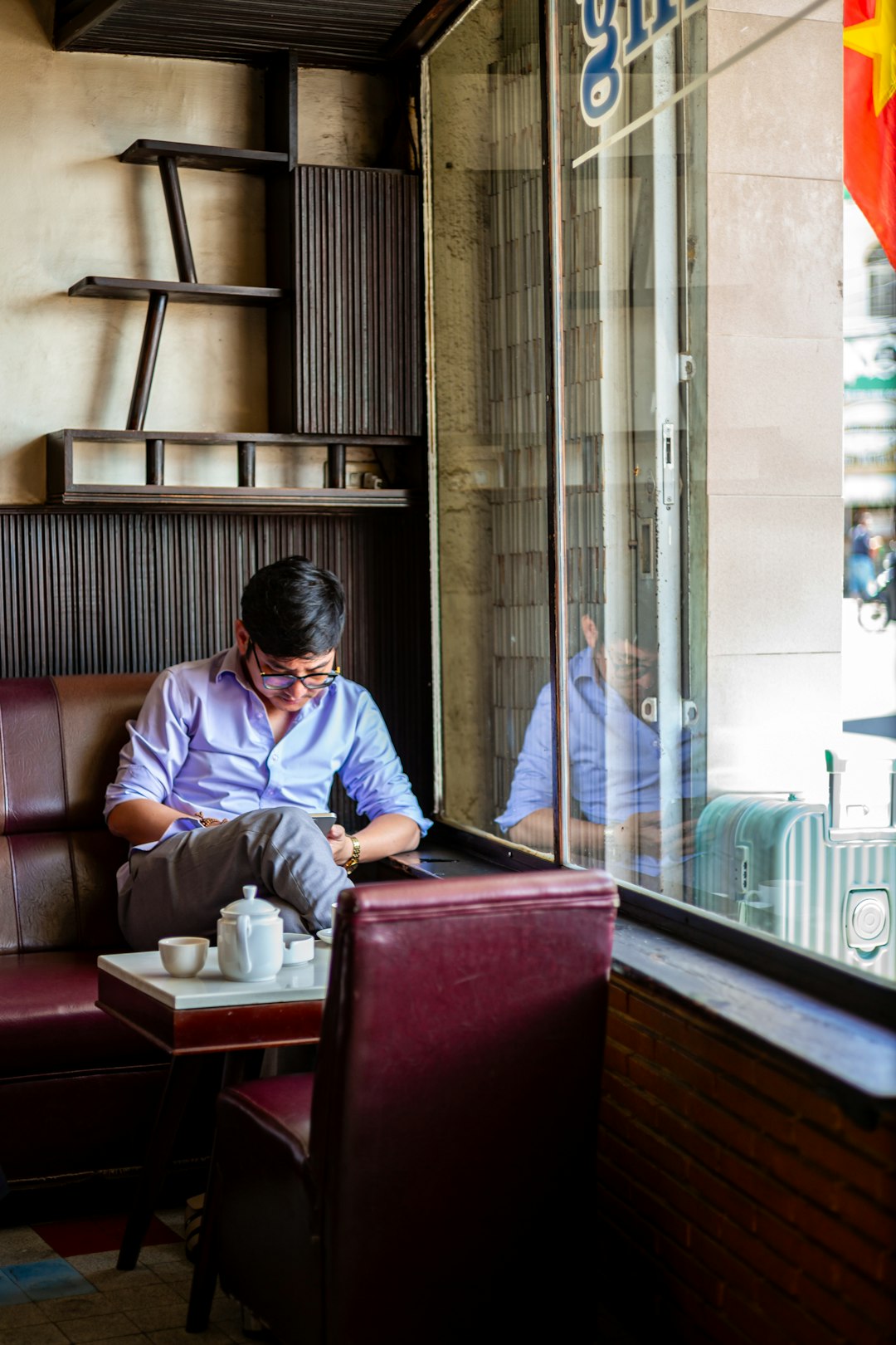 Restaurant staff member checking the weekly rota on a mobile phone in a cafe