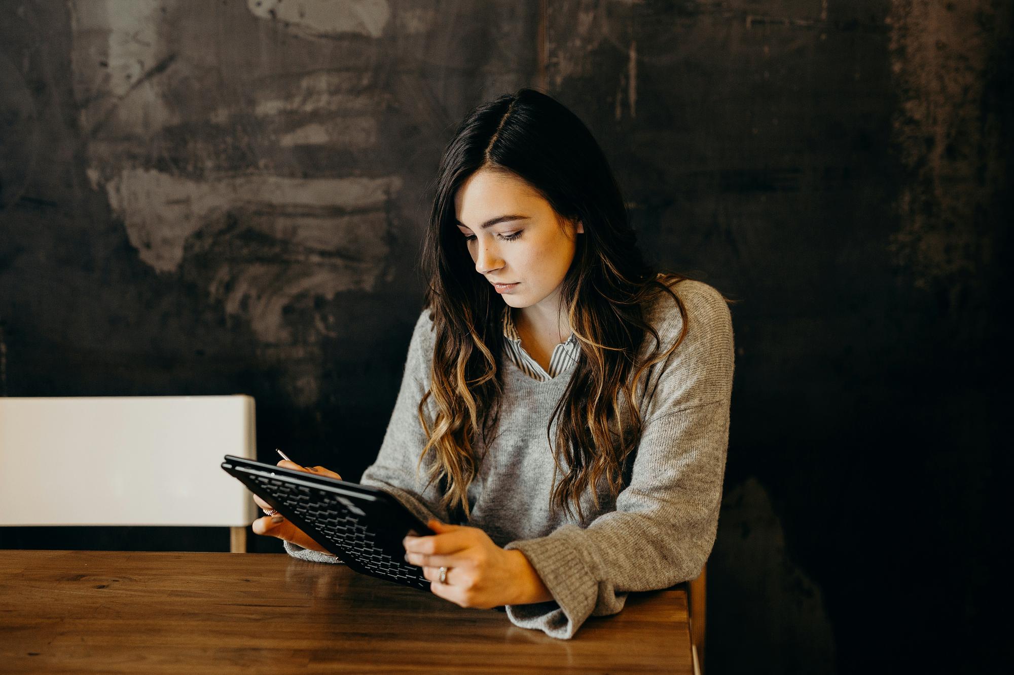 Manager reviewing a staff schedule on a tablet at work