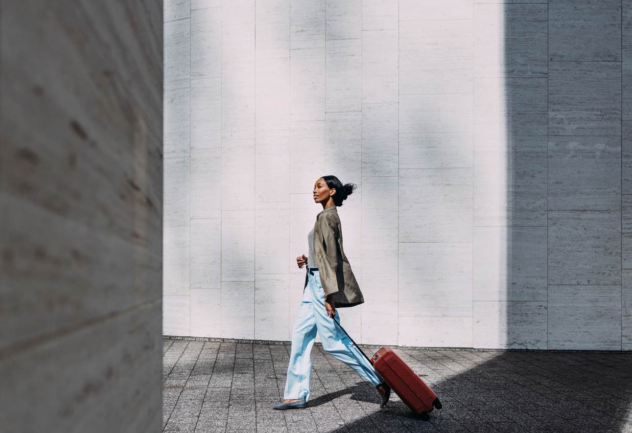 woman with red suitcase walking