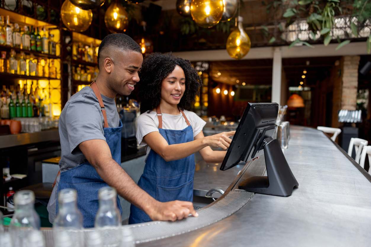Waitress training a new employee while working at a restaurant stock photo