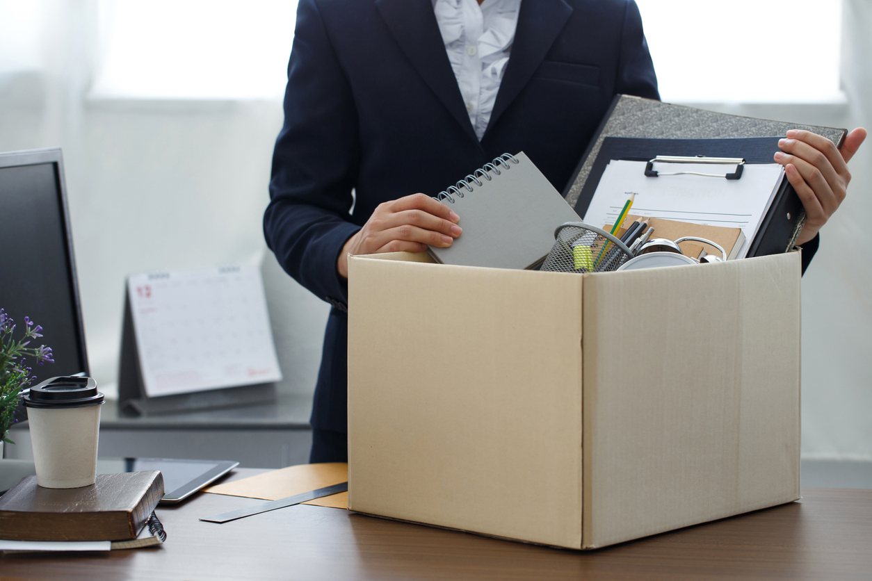 employee packing office up into cardboard box