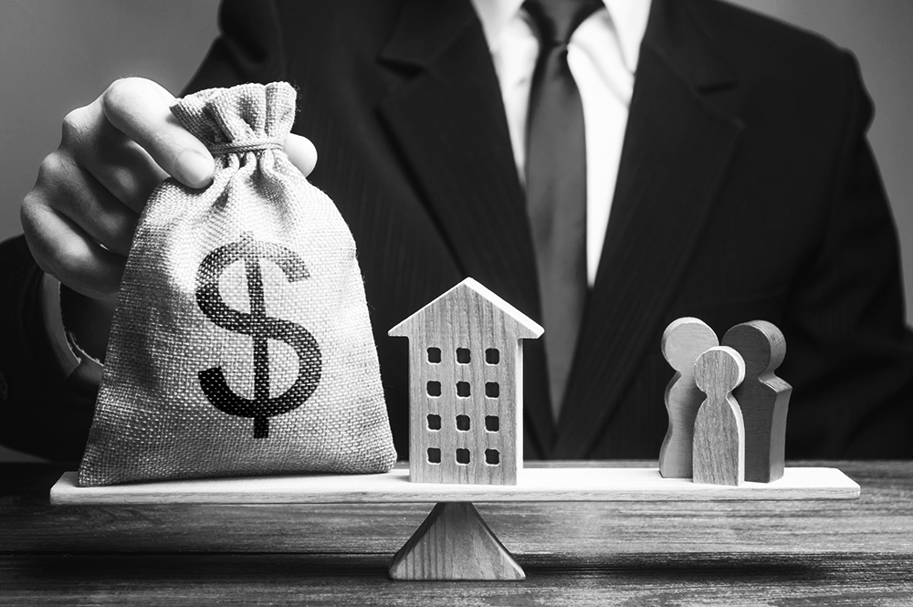 A businessman uses blocks to symbolically weigh the difference between secured and unsecured credit. 