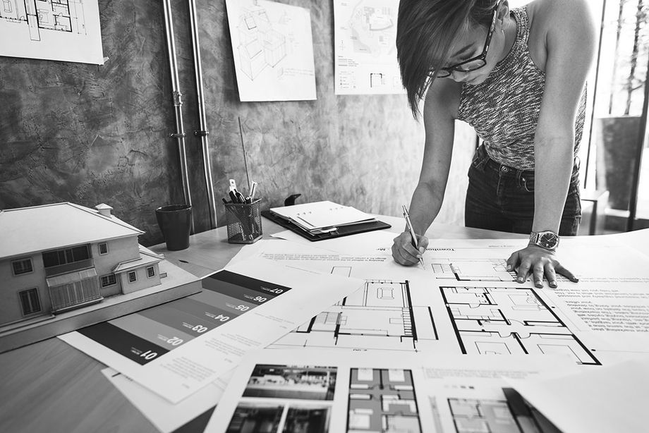 Woman working on blueprints