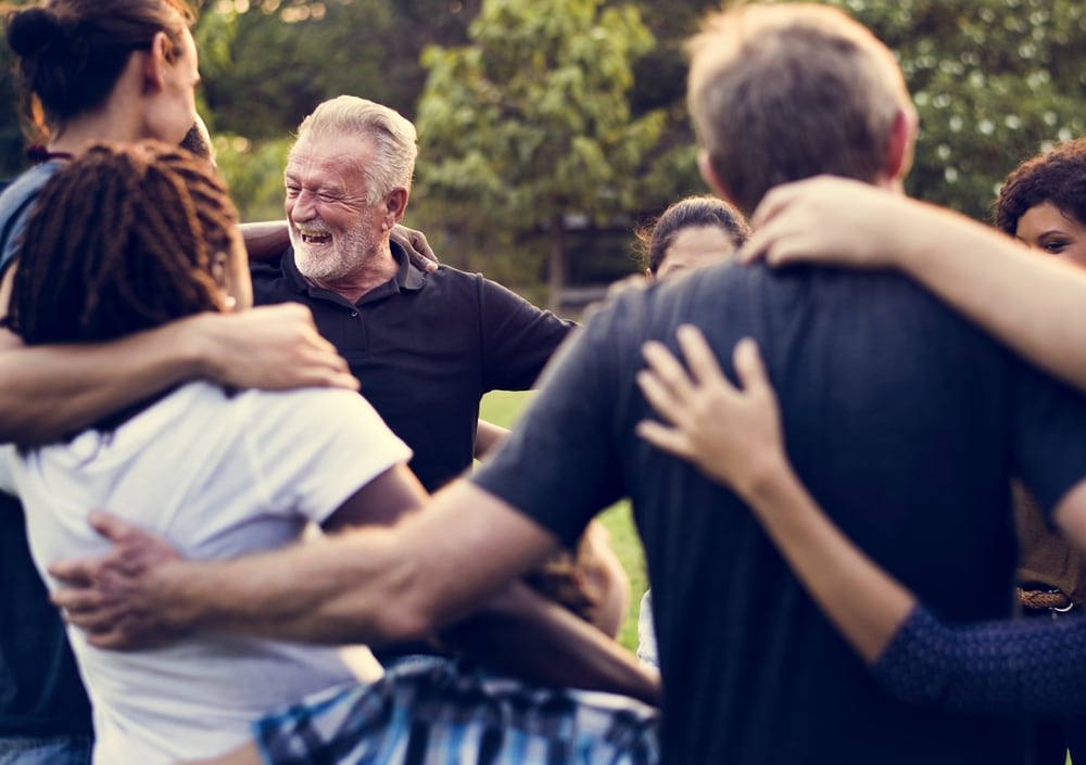 Employees and exdecutives laugh during team building activities