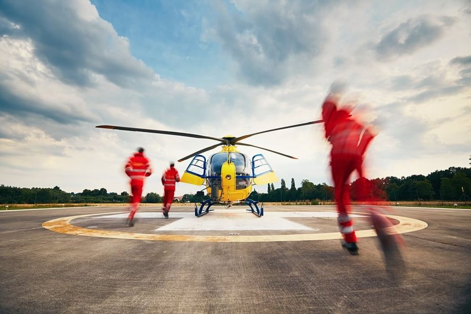 A helicopter landing on a helipad delivering medical supplies