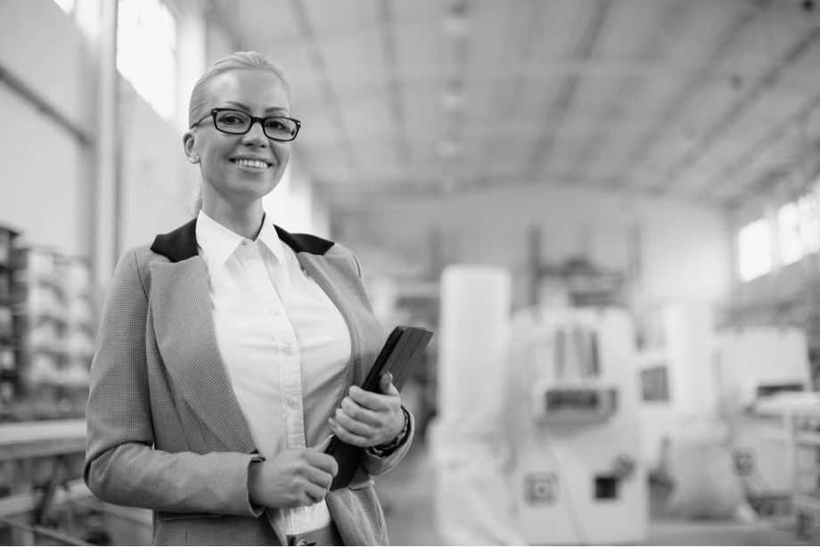 Businesswoman in factory with tablet device.