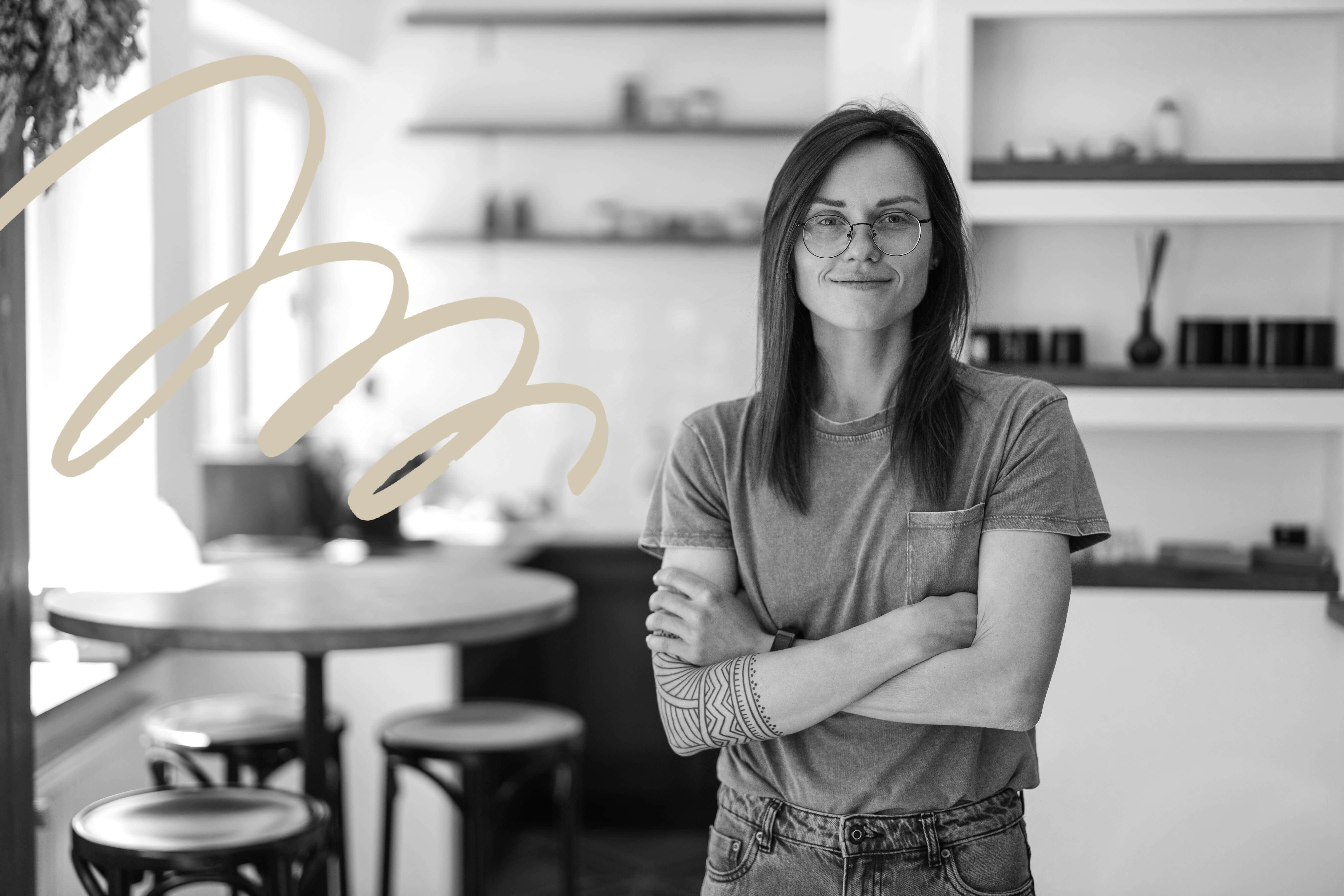 Business owner standing with her arms folded