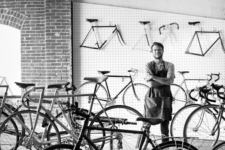 Retail bicycle store owner looking at camera