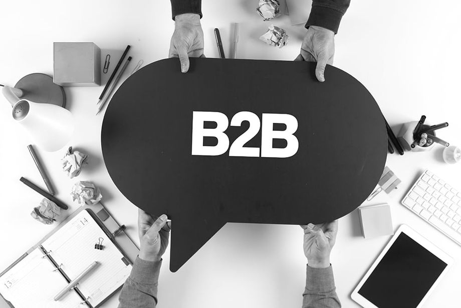 Two Marketers Holding Speech Bubble with B2B Written In It