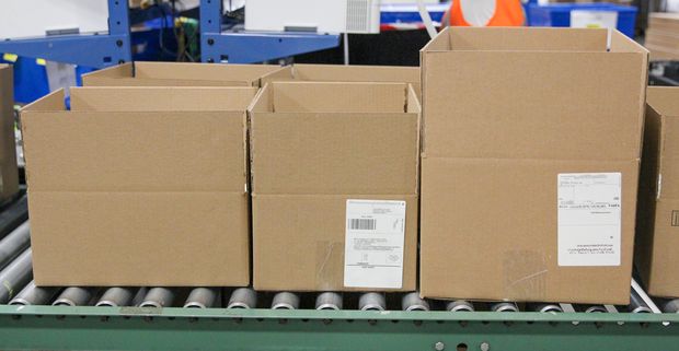 Boxes with labels on a conveyor belt in a fulfillment center