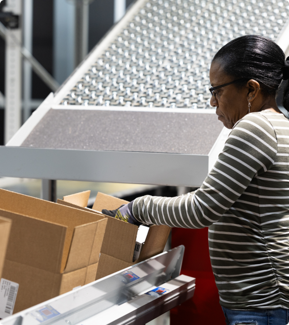 A worker backs a cardboard box