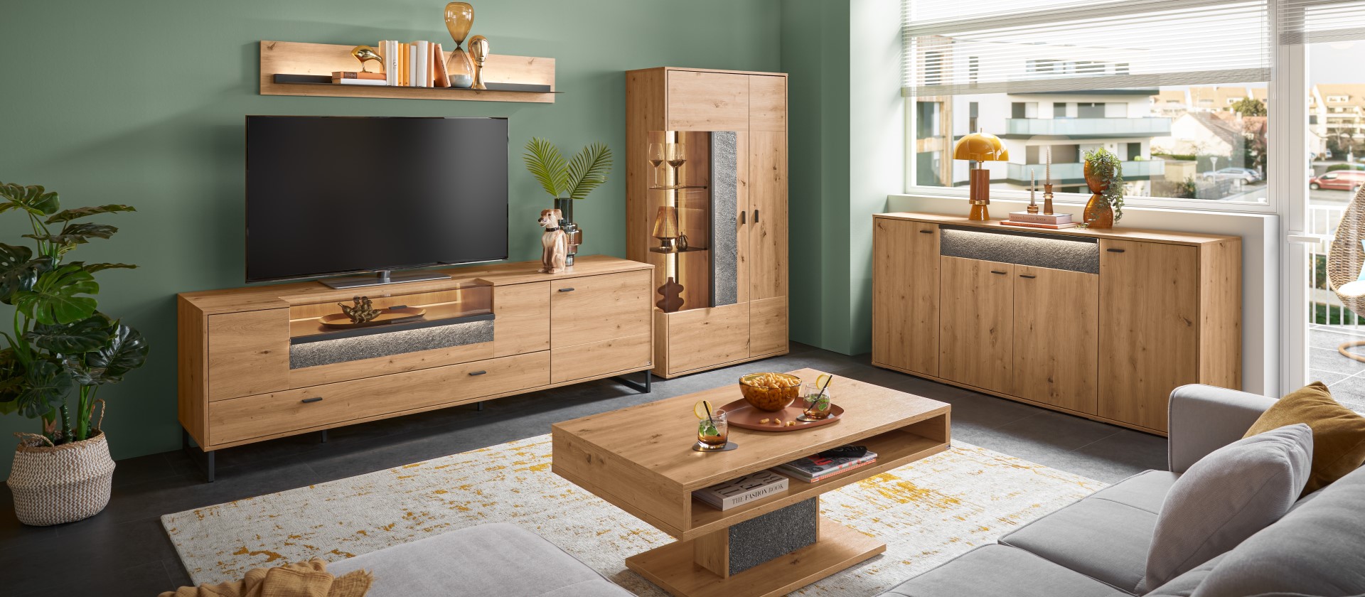 Moderne Wohnzimmereinrichtung mit Holzmöbeln der Serie Deltona von set one by Musterring. Dazu gehören Couchtisch, Vitrine und Lowboard.