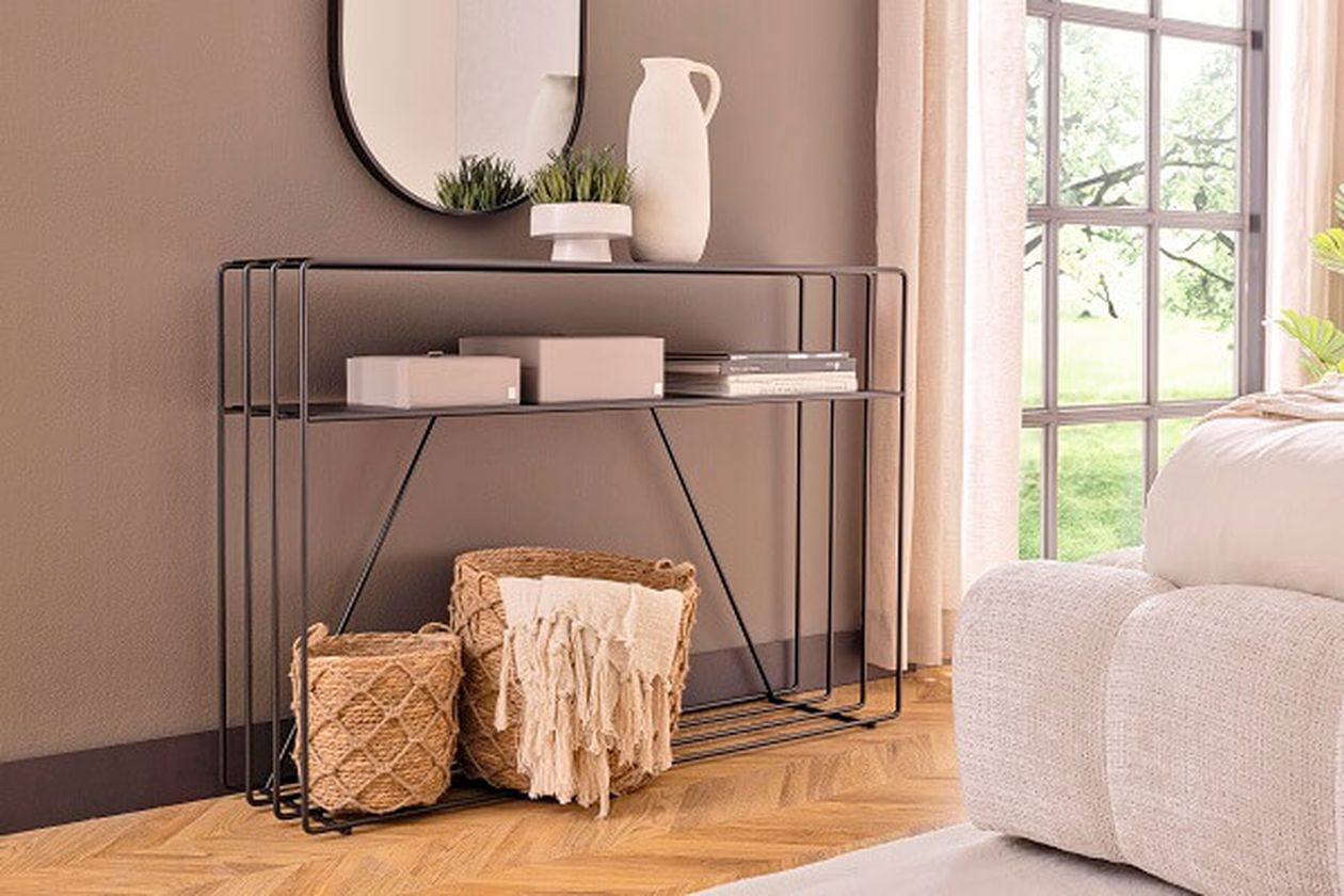 Filigranes, schwarzes Sideboard mit Körben und Deko.