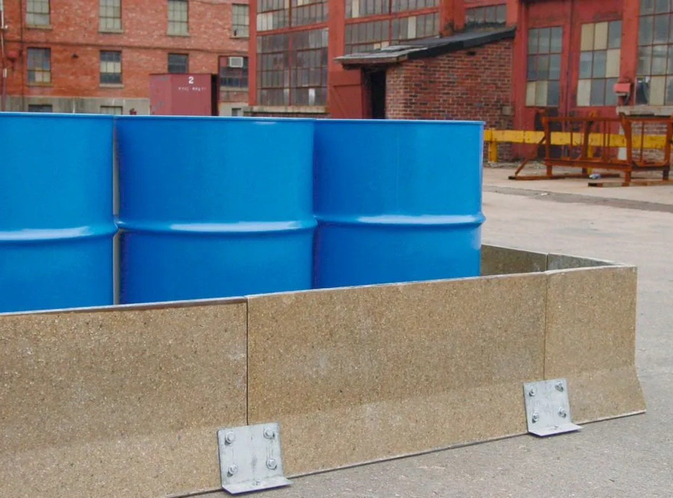 concrete berms containing large chemical drums