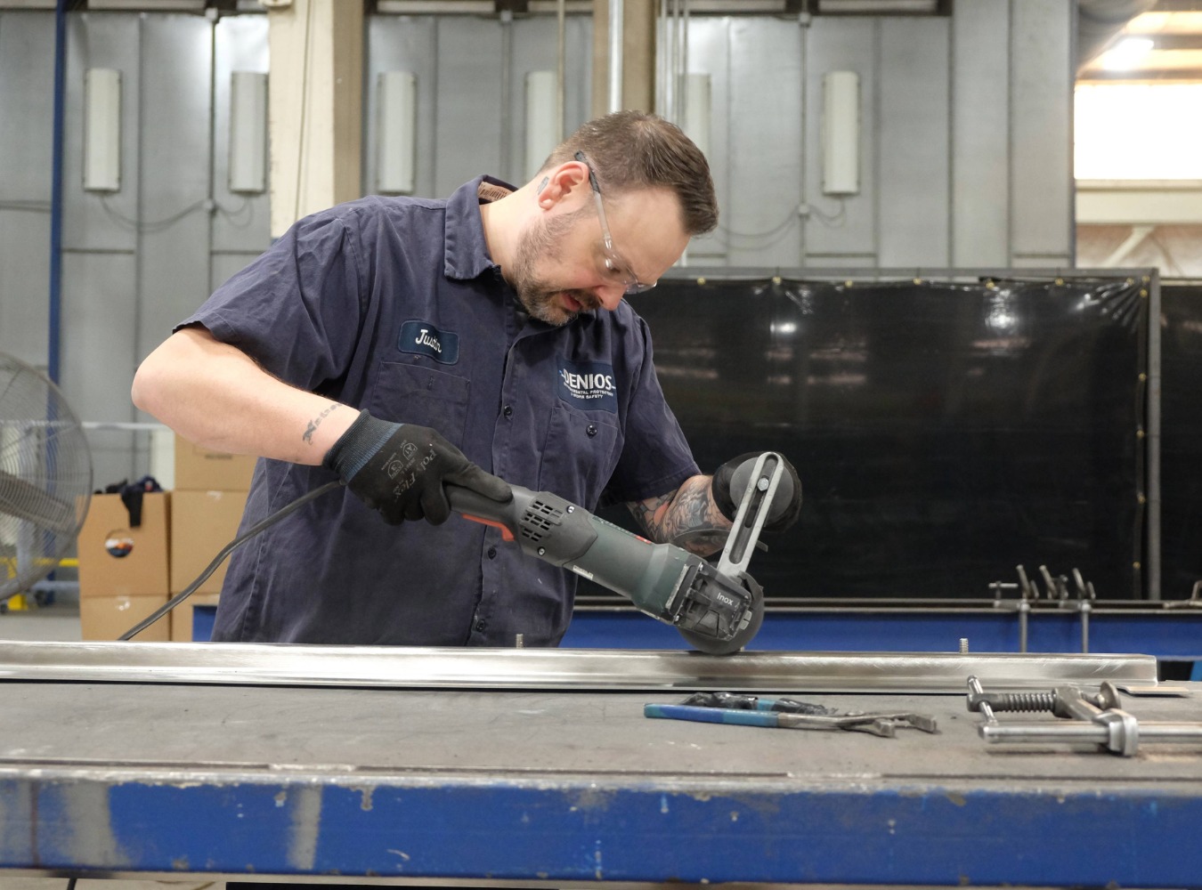a US worker building a pop-up sill barrier in an american manufacturing facillity