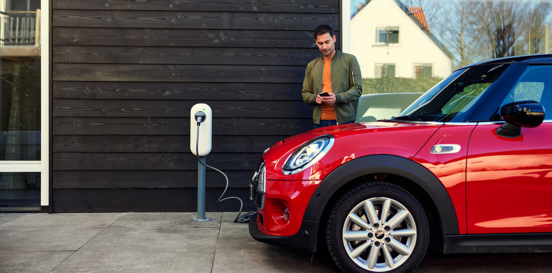 Man charging red car 