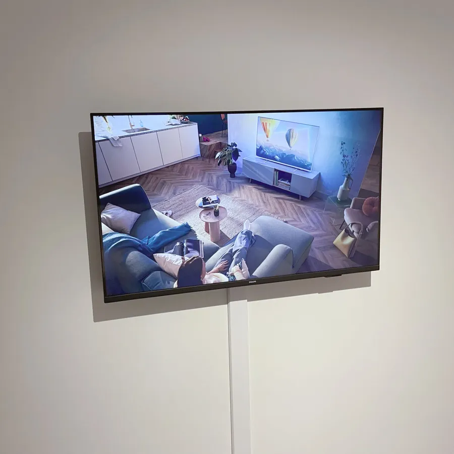 TV on white wall with white cable cover | Vogel's