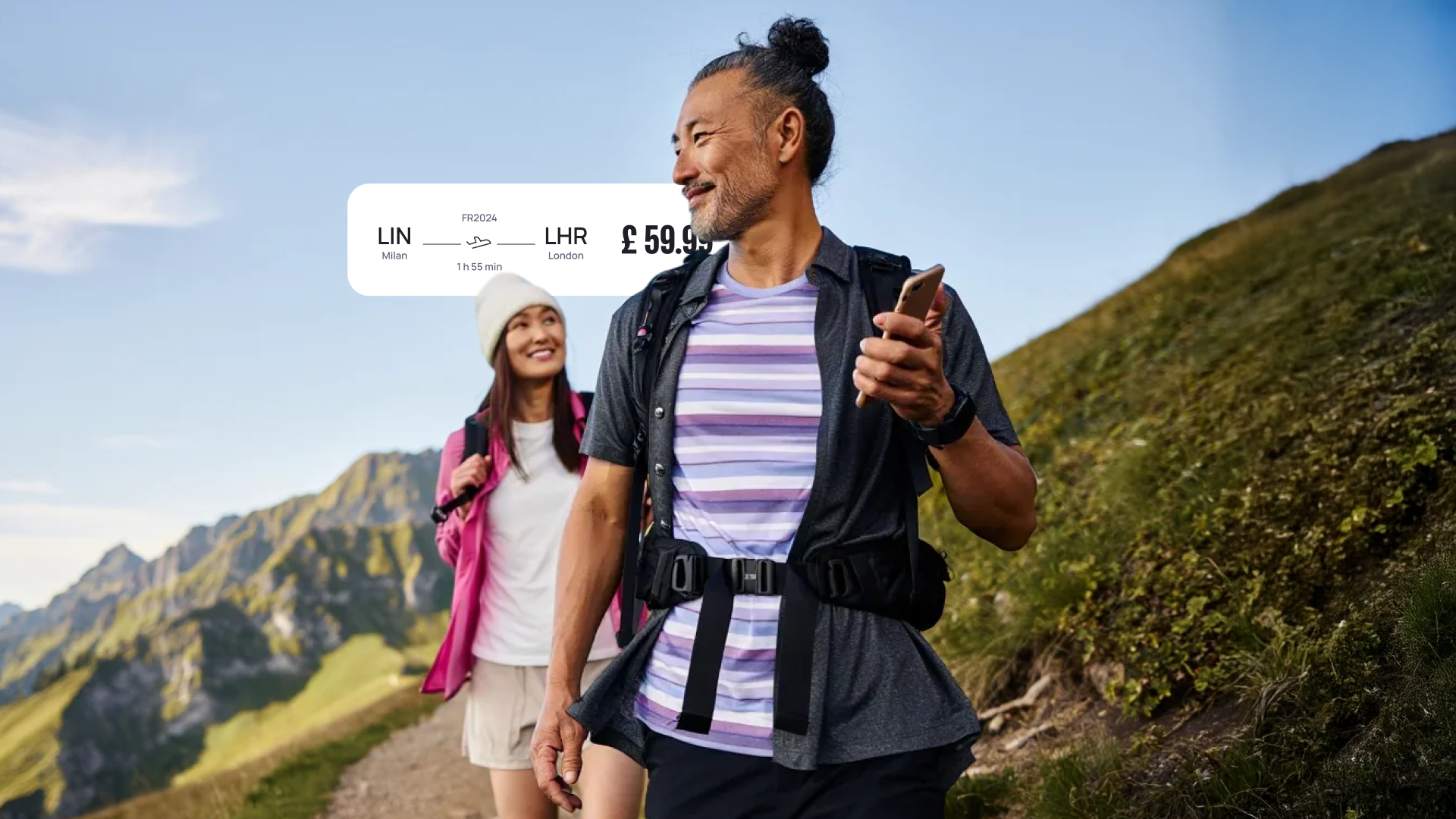 A man and woman hiking on a mountain trail, smiling, with a digital plane ticket graphic showing flight details overlaying the sky.