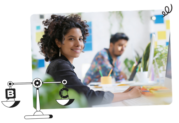 Smiling woman sitting at a desk with a blurred colleague in the background, surrounded by colorful office supplies and plants.