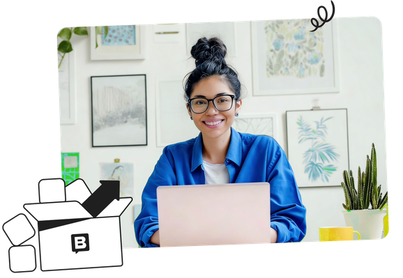 Smiling person with glasses working on a laptop at a desk, surrounded by framed art and a potted cactus. A shipping box illustration in the corner.
