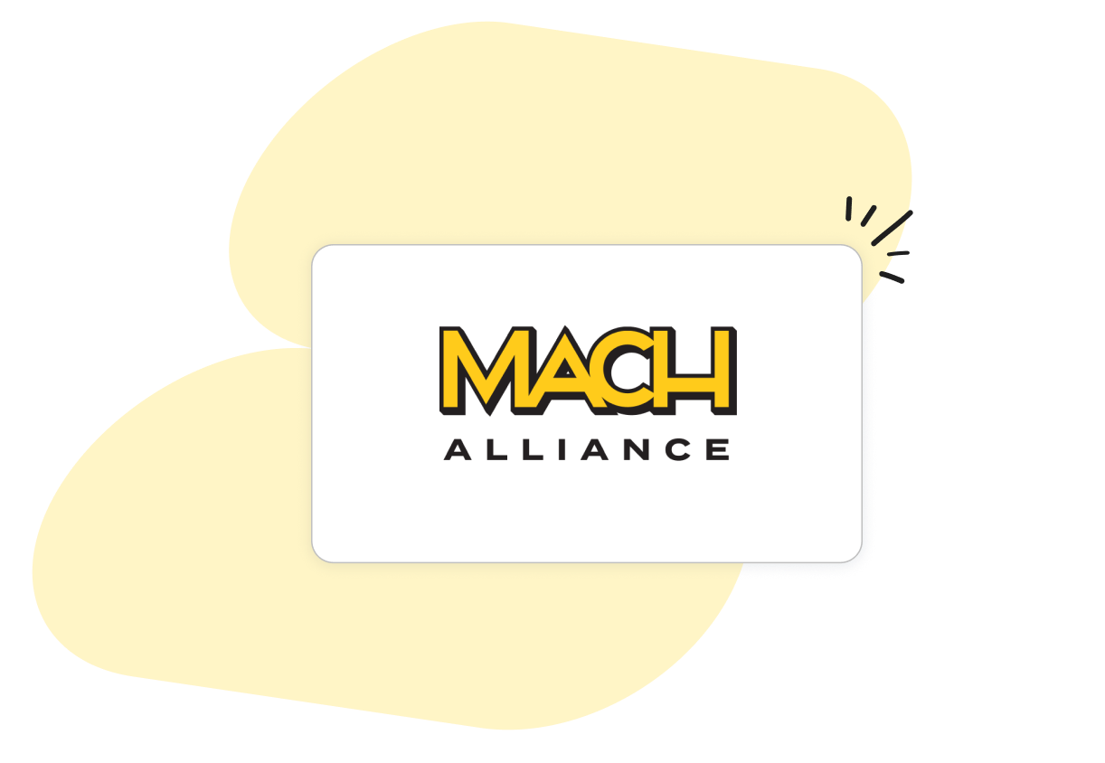 Logo of MACH Alliance on a white background with stylized yellow shapes. The text "MACH ALLIANCE" is in bold black and yellow letters.