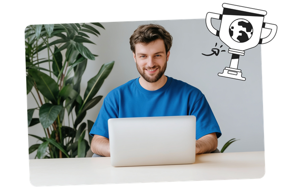 Man in a blue shirt smiling while using a laptop, with a large plant in the background and a doodle of a trophy with a globe above.