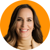 Headshot of Christina Nicholson. Smiling woman with long brown hair, wearing a beige turtleneck, against an orange background