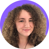 Smiling person with curly hair against a purple background.