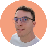 Man with short hair and glasses, wearing a white shirt, against a peach-colored circular background.