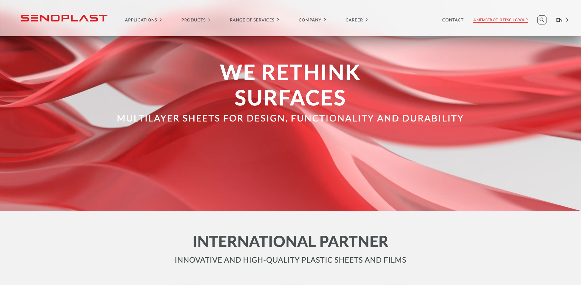 Website homepage with red abstract design and text promoting multilayer sheets for design, functionality, and durability. Company branding included.