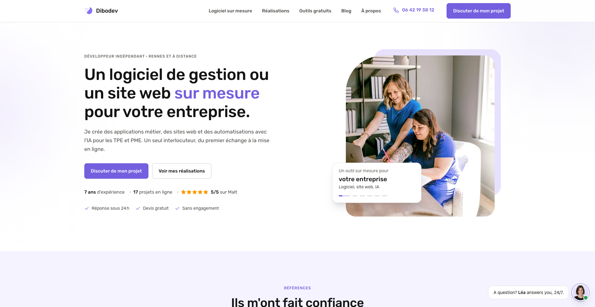 Website offering custom business software and web solutions, featuring two women collaborating on a laptop, with contact options.