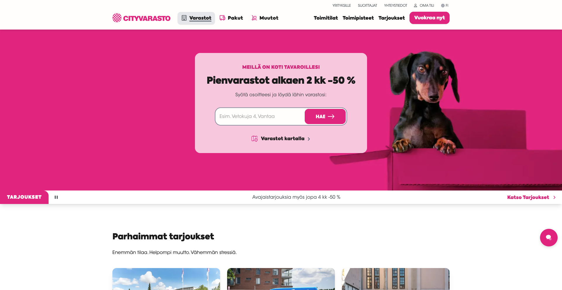 A dachshund peeks out of a pink box against a bright pink background with text promoting storage offers from Cityvarasto.